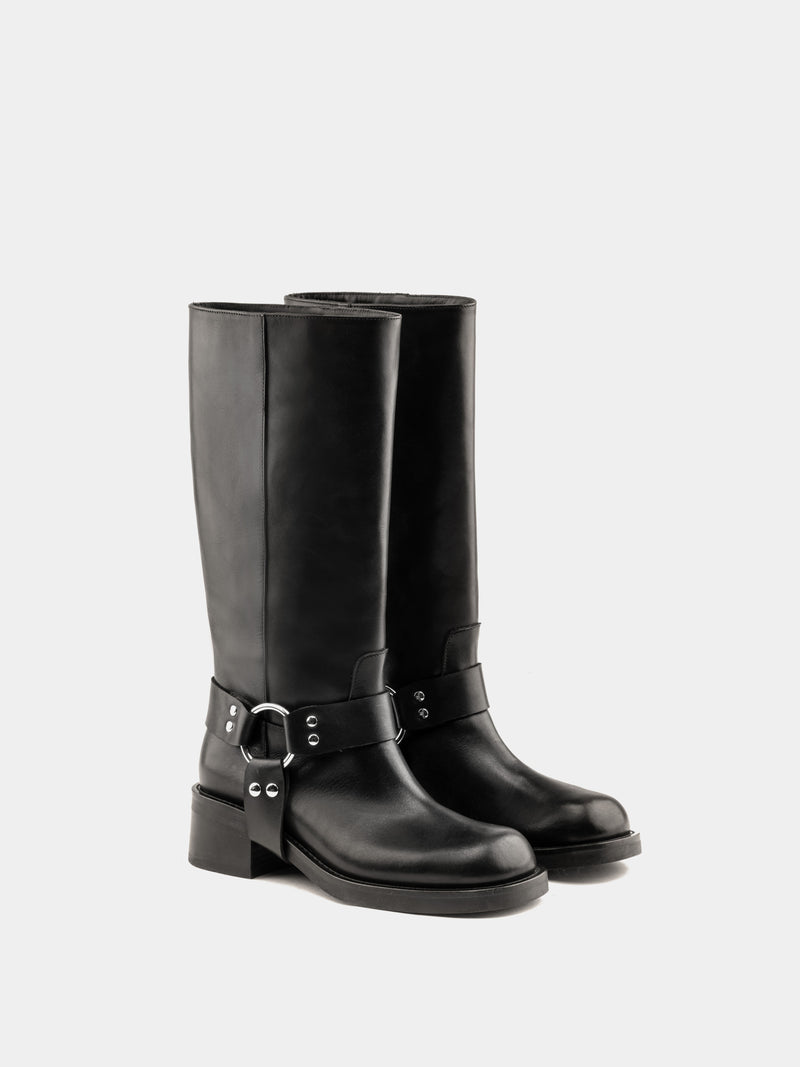 Knee-high black moto boots with a silver harness