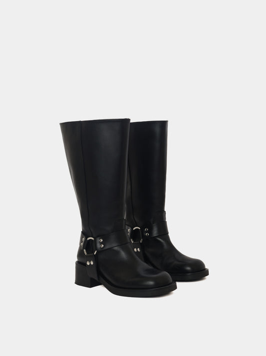 Knee-high black moto boots with a silver harness