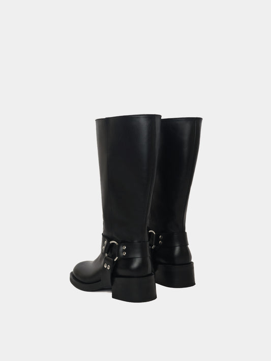 Knee-high black moto boots with a silver harness