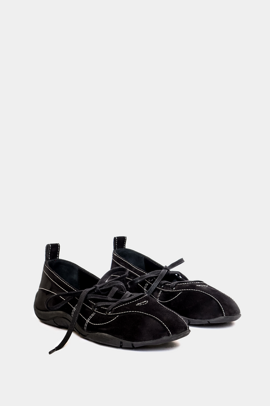 Black slip-on shoes with laces on a white background