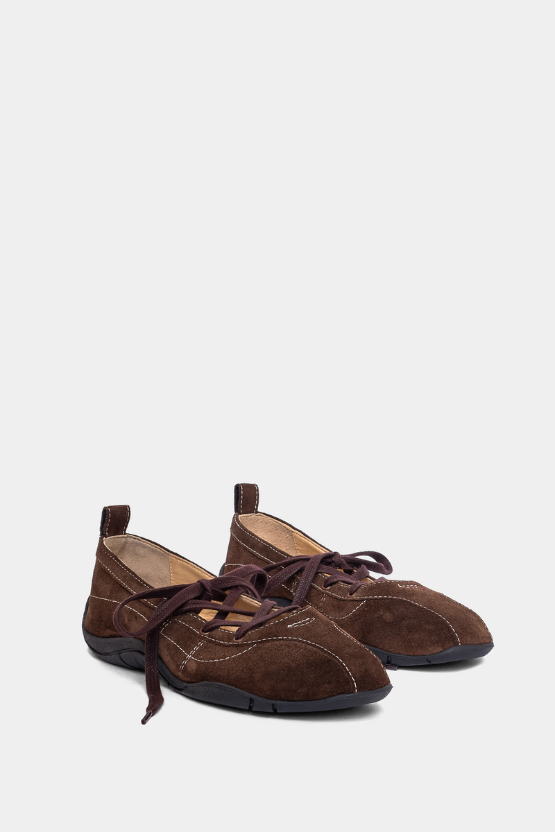 brown suede sneaker ballerina with laces, back tab & sporty black outsole on grey background