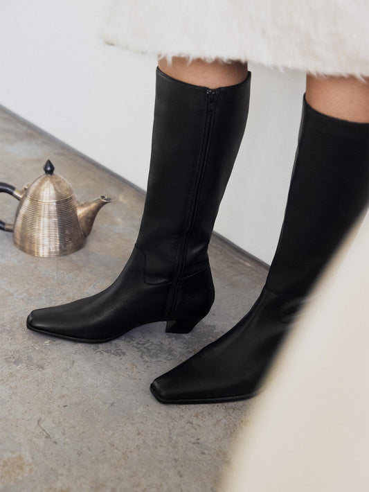 Close up on black boot with pointy toes