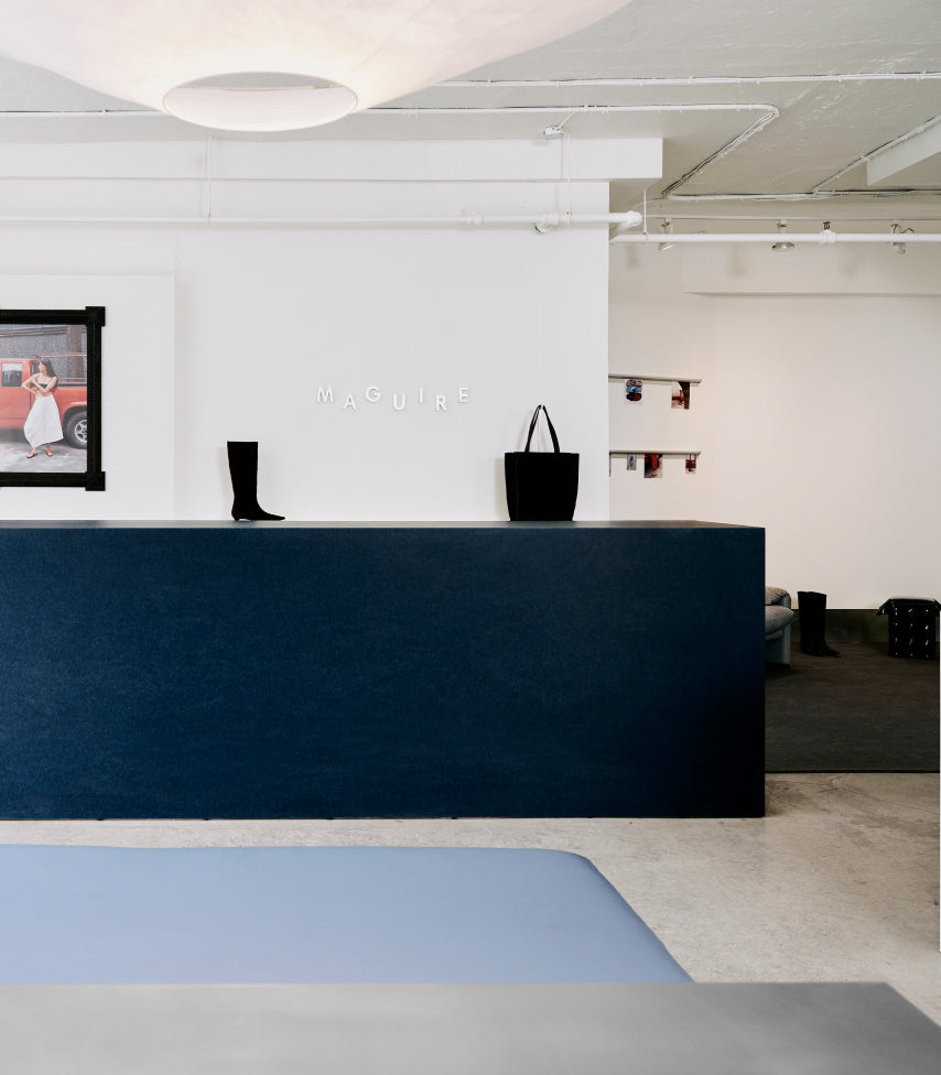 A corner of our Montreal store, featuring our signature pink sofas against warm cream walls, with our shoes beautifully displayed throughout the space.